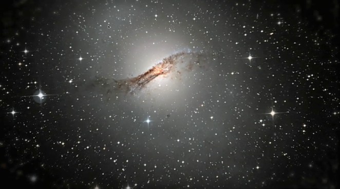 Centaurus A galaxy. Black with points of light at different sizes. In the centre a wide S shape horizontal, darker and more dense
