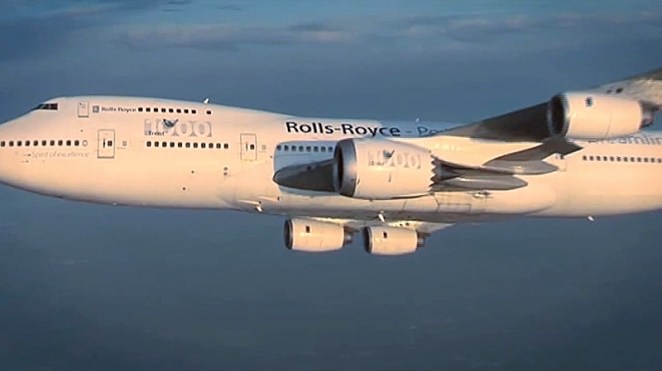 A demonstrator wide-body jet plane flying with Rolls-Royce engines