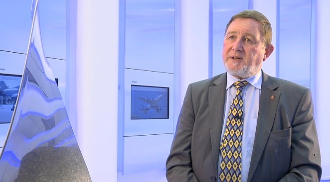 Professor Richard Parker standing next to a turbine blade