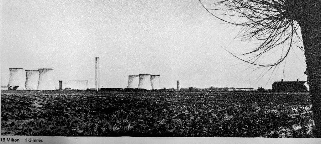 Black and white photo with drawn on cooling towers in two groups in near distance