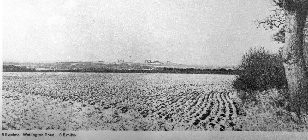 Black and white photo with cooling towers drawn on behind the hills of Wittenham Clumps