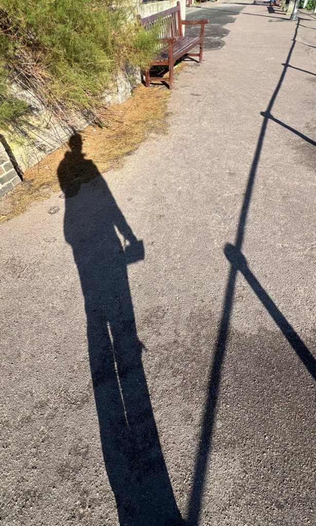 Long shadow of person on the flat ground
